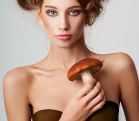 Fashion woman with mushroom hairstyle. woman portrait  with basket with mushrooms. Woman holding mushrooms. - 380962391