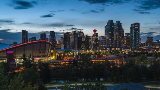 Day to night timelapse view of Calgary skyline showing high rise buildings in the financial district, Calgary, Alberta, Canada, zoom in. 