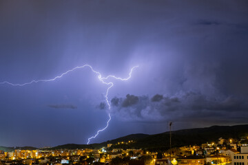 The lightning in the night sky over the city.