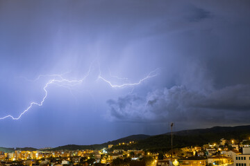 The lightning in the night sky over the city.