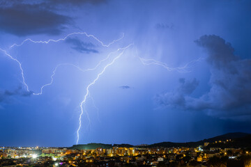 The lightning in the night sky over the city.