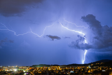 The lightning in the night sky over the city.