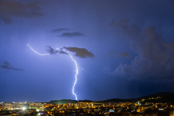 The lightning in the night sky over the city.