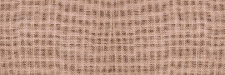 Fototapeta premium Rough hessian background with flecks of varying colors of beige and brown. with copy space. office desk concept, Hessian sackcloth burlap woven texture background..