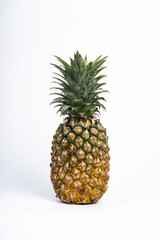 Whole fresh pineapple fruit on white background