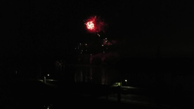 Aerial footage of fireworks over water. Rhine, Hesse, Germany.