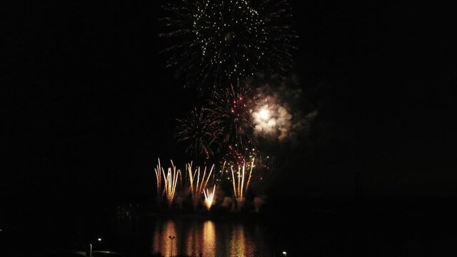 Aerial footage of fireworks over water. Rhine, Hesse, Germany.