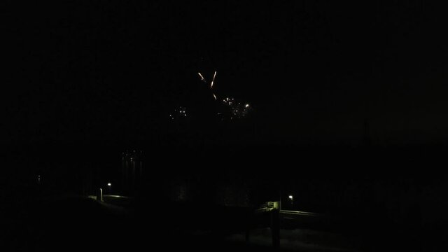 Aerial footage of fireworks over water. Rhine, Hesse, Germany.