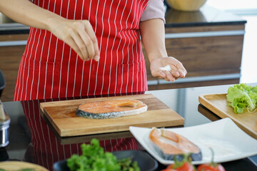 hands of woman preparing cooking organic healthy food in the kitchen