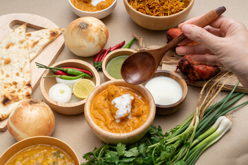 Various indian food menus, biryani rice, butter chicken, tandoori, bean curry and naan bread