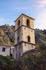 Fototapeta na wymiar Old Town of Kotor - UNESCO World Heritage site. View of Bell Tower of Church of St. Mary (XIII century) on sunny winter day. Montenegro