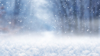 Christmas and New Year background, snow cover and forest in defocus during snowfall