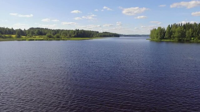Fast backwards moving drone shot of lake Pielinen in Karelia