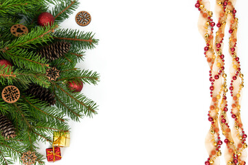 Branches of a Christmas tree and red and yellow gift boxes and balls on a white background. Christmas background with copyspace.