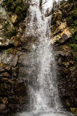 Big waterfall with rocky background