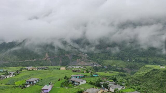 A beautiful lush green monsoon morning view of a village from an offbeat hill station in India