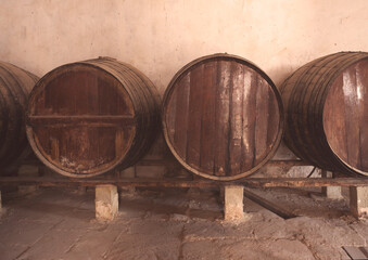 Wine barrels stacked in the old cellar of the vinery in Spain