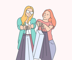 Girls or womans are carrying a shopping bag after big sale. Good shopping on black friday. Hand drawn thin line style, vector illustrations.