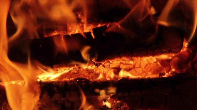 Burning Firewood Coal Close up in the Fireplace. Fire Fireplace Ember Wood Home Embers Closeup. Glowing Embers in Hot Red Collor. static tripod shoot.