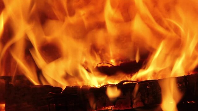 Burning Firewood Coal Close up in the Fireplace. Fire Fireplace Ember Wood Home Embers Closeup. Glowing Embers in Hot Red Collor. static tripod shoot.