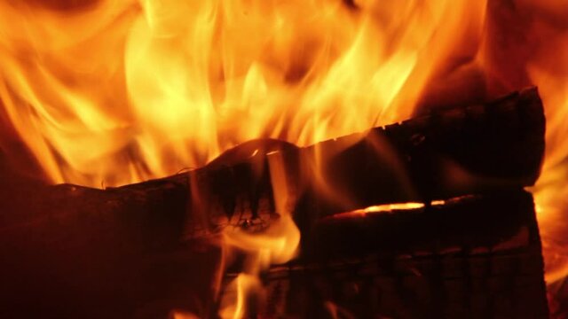 Burning Firewood Coal Close up in the Fireplace. Fire Fireplace Ember Wood Home Embers Closeup. Glowing Embers in Hot Red Collor. static tripod shoot.