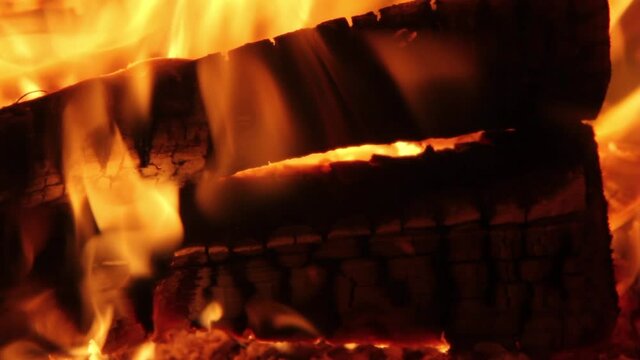 Burning Firewood Coal Close up in the Fireplace. Fire Fireplace Ember Wood Home Embers Closeup. Glowing Embers in Hot Red Collor. static tripod shoot.