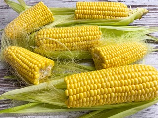 Close-up of ripe raw corn swings on an abstract wooden surface.The concept of proper healthy nutrition, agriculture.