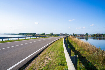 A beautiful automobile asphalt road without cars and people.