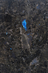 Texture of natural black labradorite stone. Natural blue mineral stone labradorite crystal in the rock. High resolution photo.  