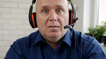 Image with a Person Using a Laptop and Headphones for an Online Video Conference