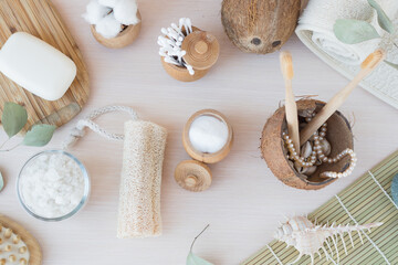 Fototapeta na wymiar Beauty and fashion concept with spa setting. composition with Dead sea salt, coconut, natural cosmetic blue clay, soda, loofah. Flat lay, Spa concept with cotton flower, stones and towel.