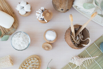 Beauty and fashion concept with spa setting. composition with Dead sea salt, coconut,  natural cosmetic blue clay,  soda, loofah. Flat lay, Spa concept with cotton flower, stones and towel.