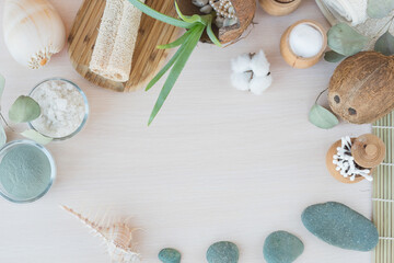 Beauty and fashion concept with spa setting. composition with Dead sea salt, coconut,  natural cosmetic blue clay,  soda, loofah. Flat lay, Spa concept with cotton flower, stones and towel.