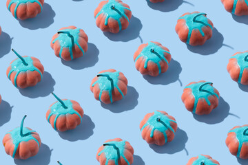Autumn composition. Pattern made with colorful pumpkins on pastel blue background. Halloween, Thanksgiving or fall minimal concept. Flat lay, top view.