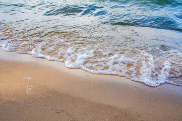Transparent sea wave on a clean sandy seashoreа