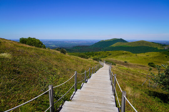 wooden pathway tourist staircase for access easy on hight mountain Puy de Dôme volcano in Auvergne france © OceanProd