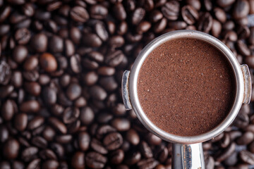 Filter holder with ground coffee and roasted coffee beans .