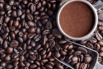 Filter holder with ground coffee and roasted coffee beans .