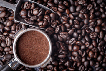 Filter holder with ground coffee and roasted coffee beans .