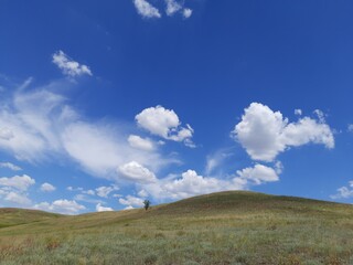 Hills, clouds and blue sky