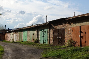 Fototapeta na wymiar Private car garages in Russia. Old gloomy buildings