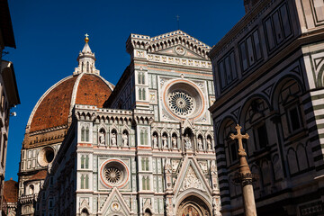 Obraz premium Close up. The white marble facade (exterior) of the central church (Duomo), also known as Santa Maria del Fiore Cathedral, with the tower and the Renaissance dome in Florence, Tuscany, Italy. Europe