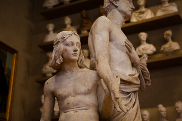 Close up. The white marble  Renaissance sculptures of a boy & a man created by the Italian artist at the gallery in Florence, Tuscany, Italy. European heritage.