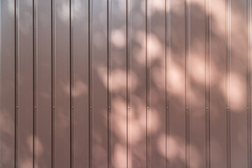 garage door texture in brown nearly wooden pattern with shadows and sun
