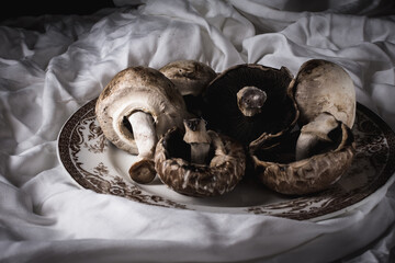 mushrooms mushrooms on a rustic white cloth on a white plate and fork