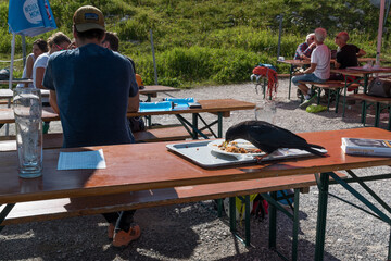 Hungry bird eating the meal from Tourists at the mountain station from the Alpspitze cable car in Germany.