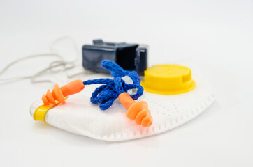 industrial earplugs and respirator on a white background.
