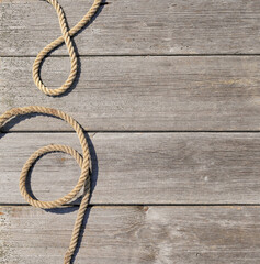 Obraz premium Ship rope on old wooden texture background with copy space