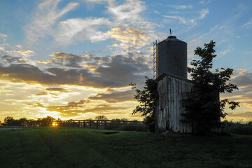 Sunrise and grain silo at a farm
