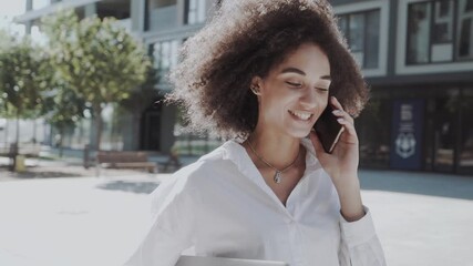 Beautiful african american woman at cellphone outdoors